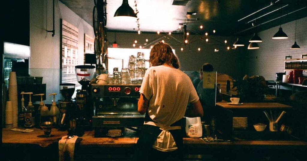 A barista working on the coffee machine