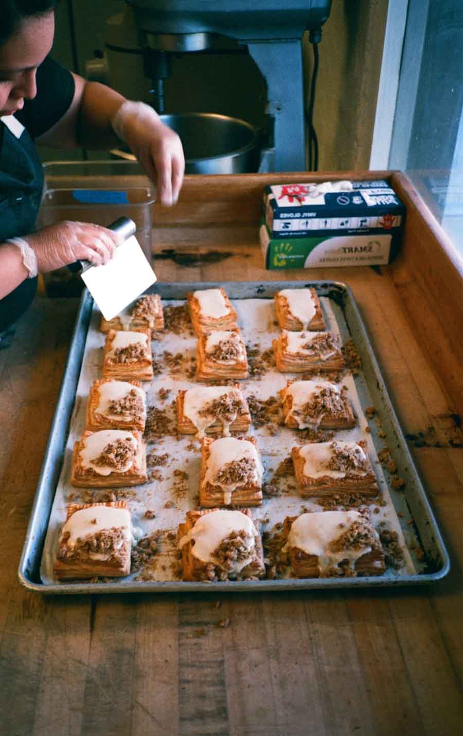 A staff preparing a dessert/pastry