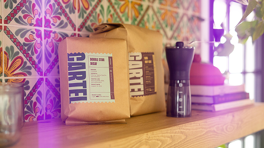 Two coffee bags with coffee grinder